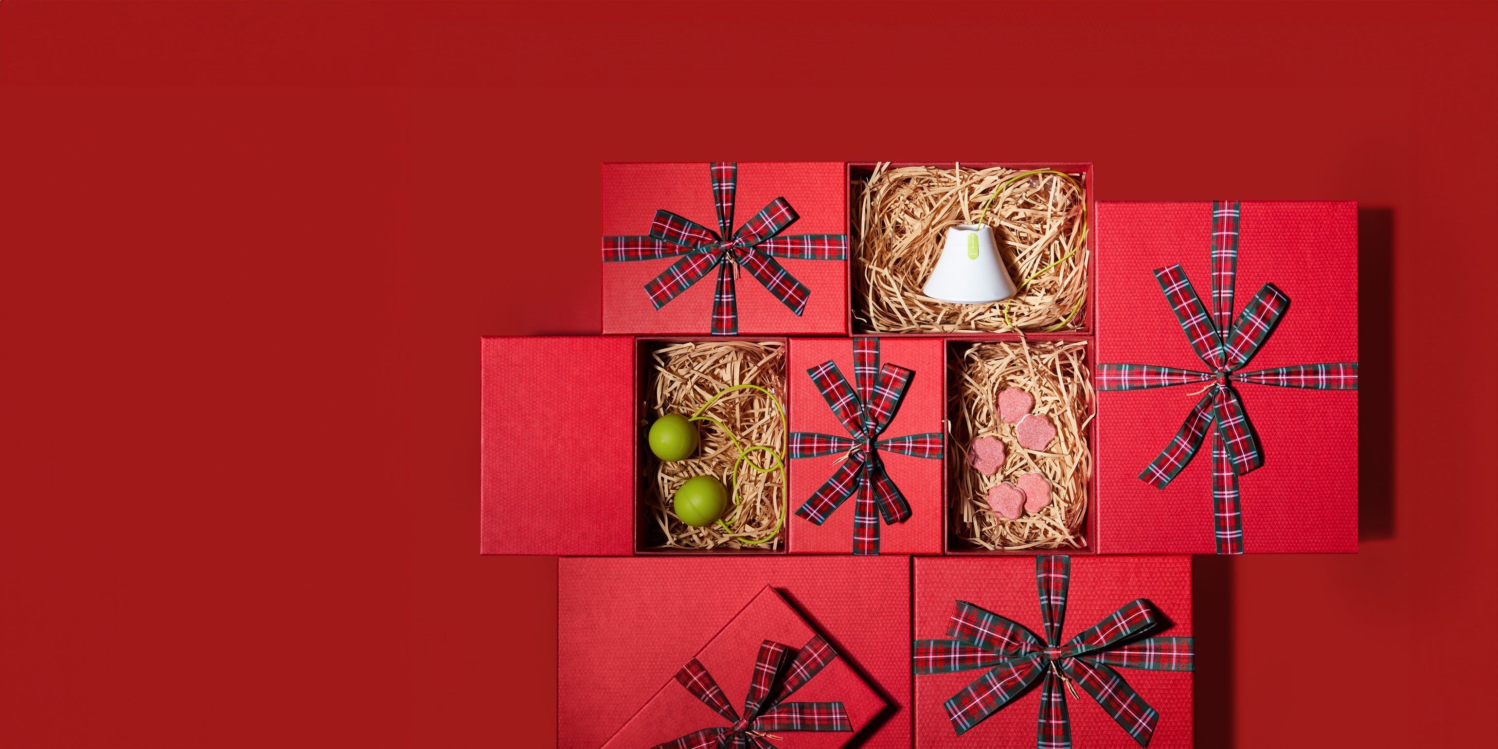 Hand holding a white dishwasher tablet against a blue sky background