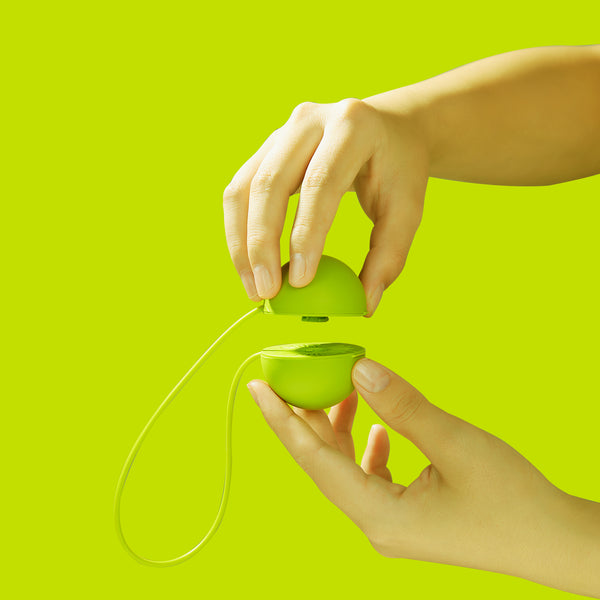 A hand adding a hand soap refill tablet to a hand soap bottle