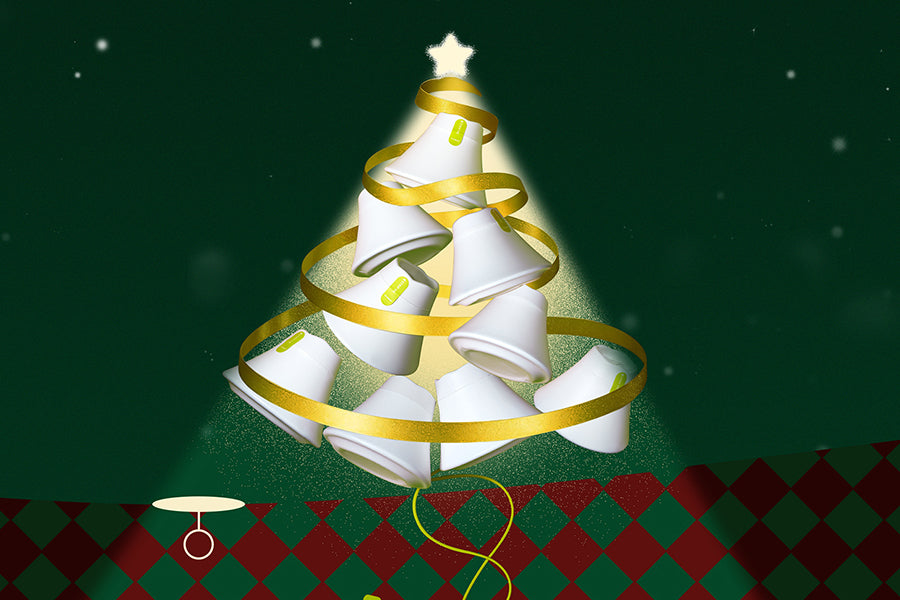 Hand holding a white dishwasher tablet against a blue sky background