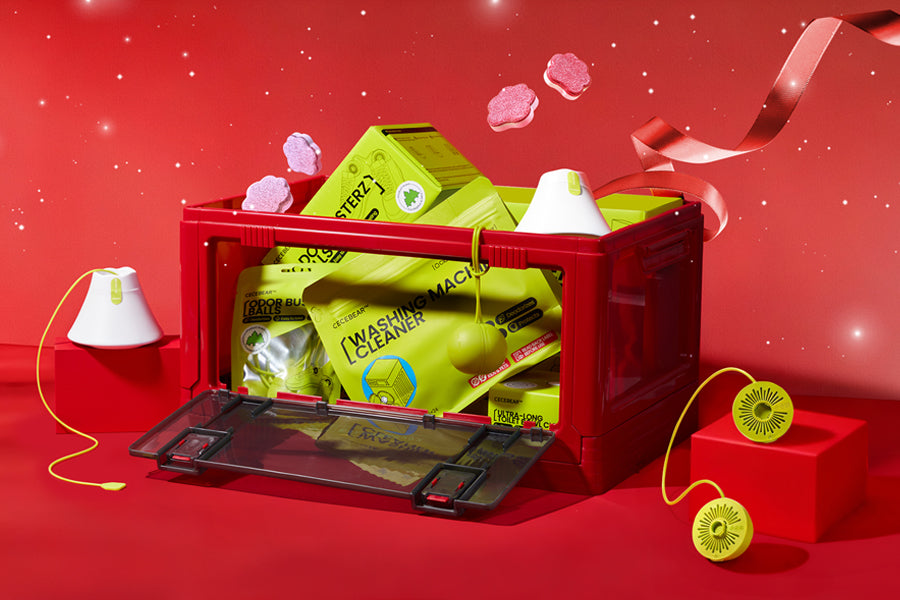 Hand holding a white dishwasher tablet against a blue sky background